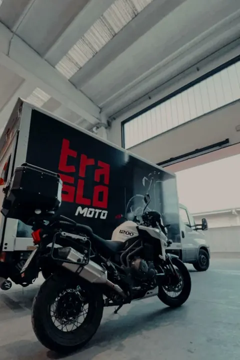 Motorcycle in front of the TrasloMoto van in the warehouse